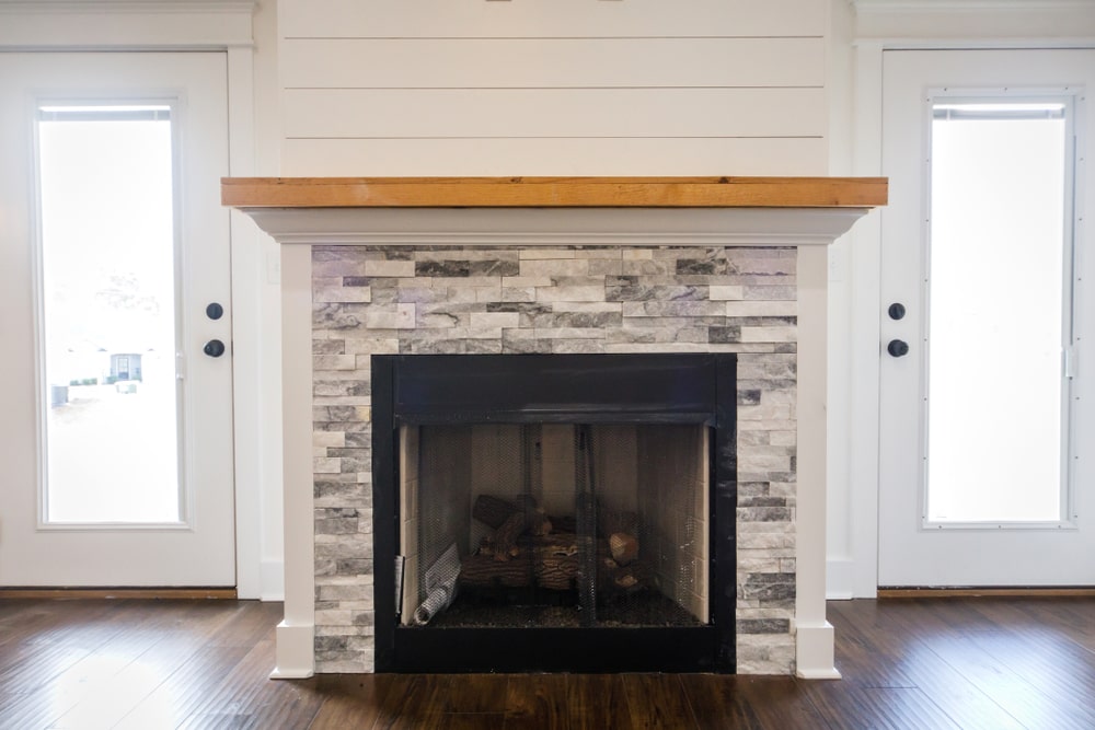 Modern open spacious living room with shiplap over fireplace. (electric fireplace)