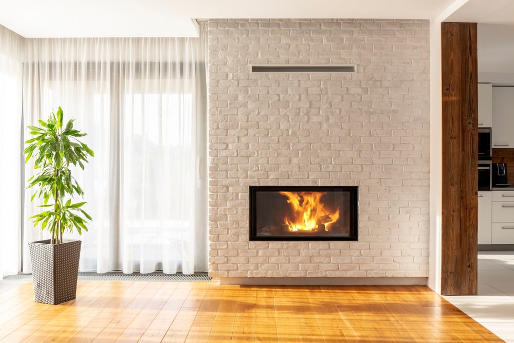 Whitewashed bricks and fireplace in a living room. (electric fireplace)